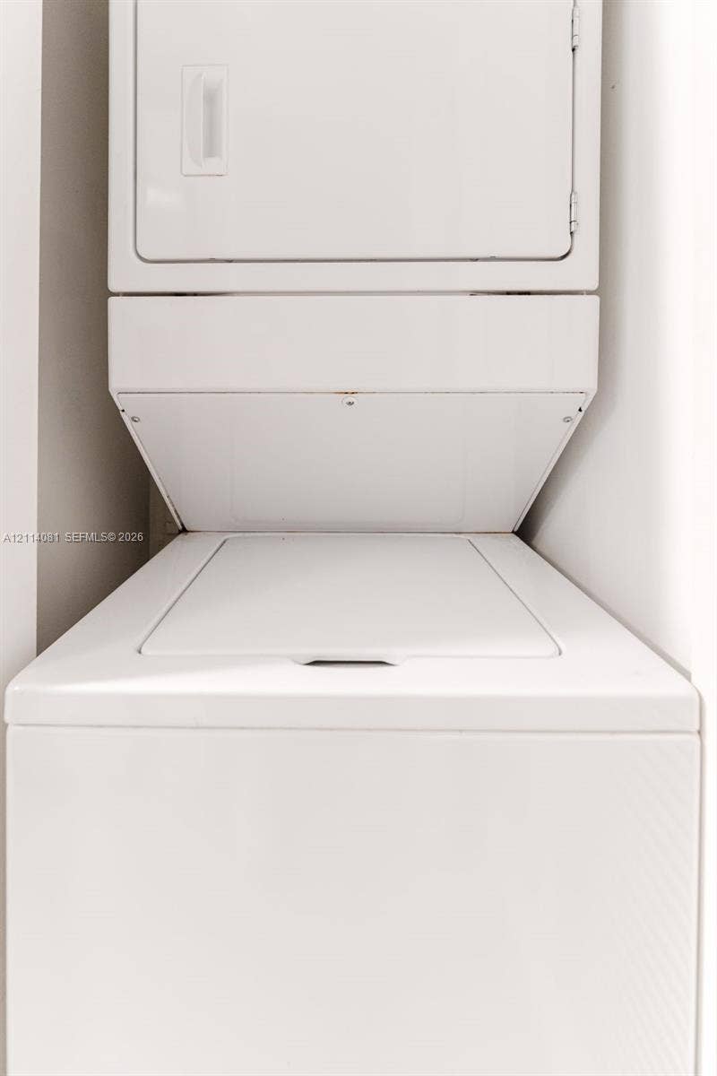 185 SW 7th Street, #3609, Miami, Miami, FL 33130 Stacked white top-load washer and dryer unit
