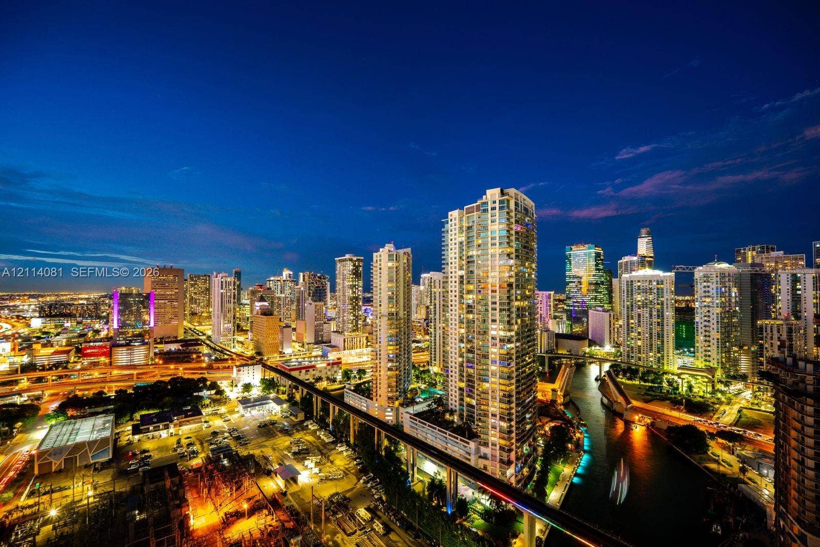 185 SW 7th Street, #3609, Miami, Miami, FL 33130 High-rise perspective featuring panoramic urban skyline, waterway, and illuminated infrastructure