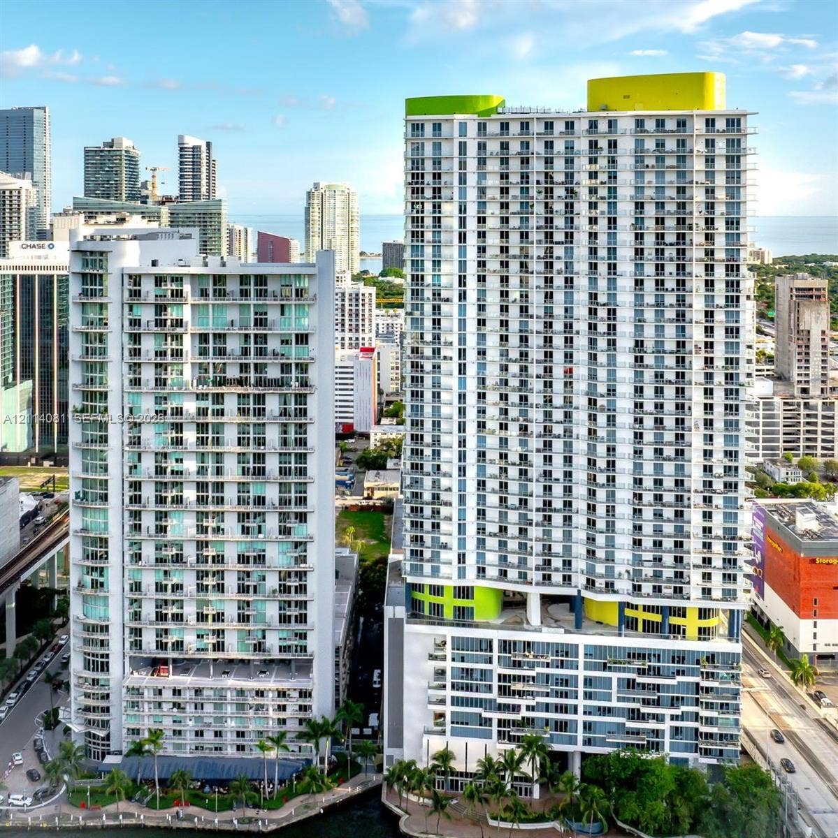 185 SW 7th Street, #3609, Miami, Miami, FL 33130 High-rise concrete structure featuring extensive glass balconies, floor-to-ceiling windows, and integrated rooftop architectural elements