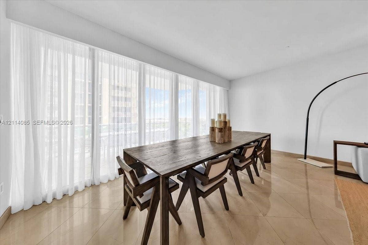 10101 Collins Avenue, #8D, Bal Harbour, FL 33154 Floor-to-ceiling windows with expansive wall-to-wall treatment and polished stone-finish flooring
