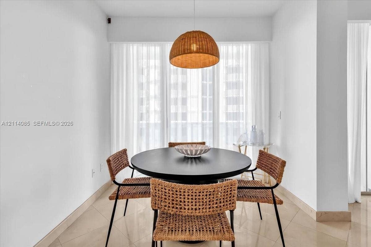 10101 Collins Avenue, #8D, Bal Harbour, FL 33154 Woven dome pendant light, large-format tile flooring, and floor-to-ceiling sheer window treatments