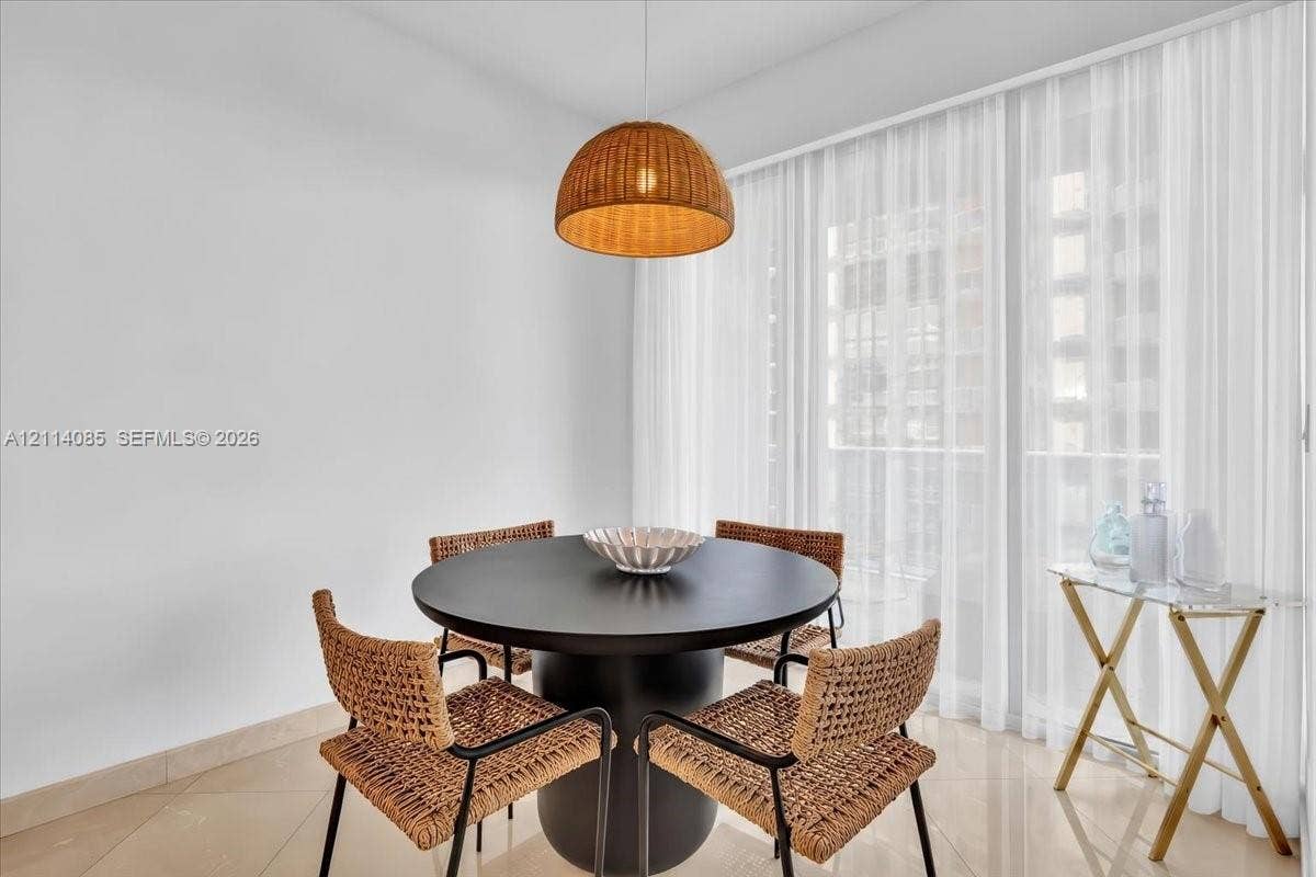 10101 Collins Avenue, #8D, Bal Harbour, FL 33154 Woven dome pendant light, large-format tile flooring, and floor-to-ceiling sheer window treatments