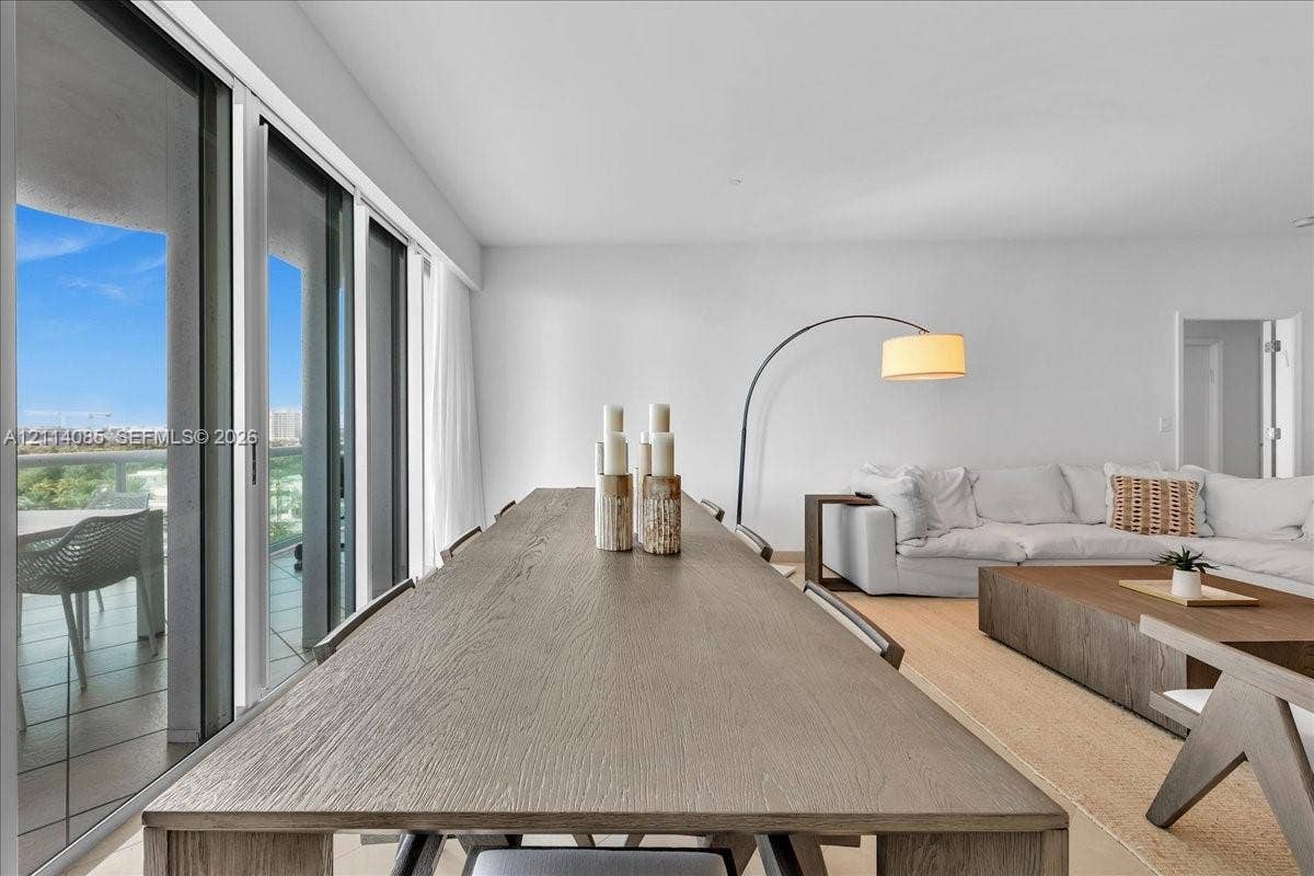 10101 Collins Avenue, #8D, Bal Harbour, FL 33154 Floor-to-ceiling sliding glass doors, neutral interior walls, and wood-finish flooring