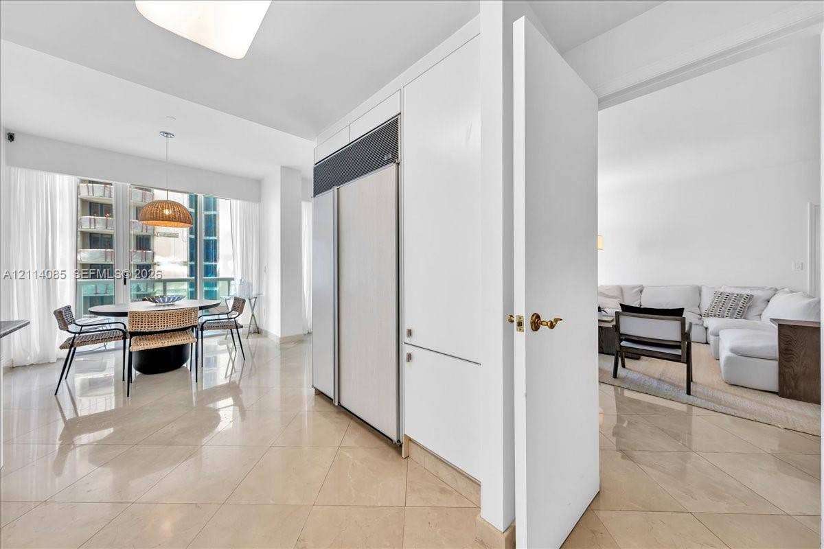 10101 Collins Avenue, #8D, Bal Harbour, FL 33154 Panel-ready refrigerator, polished tile flooring, and floor-to-ceiling windows