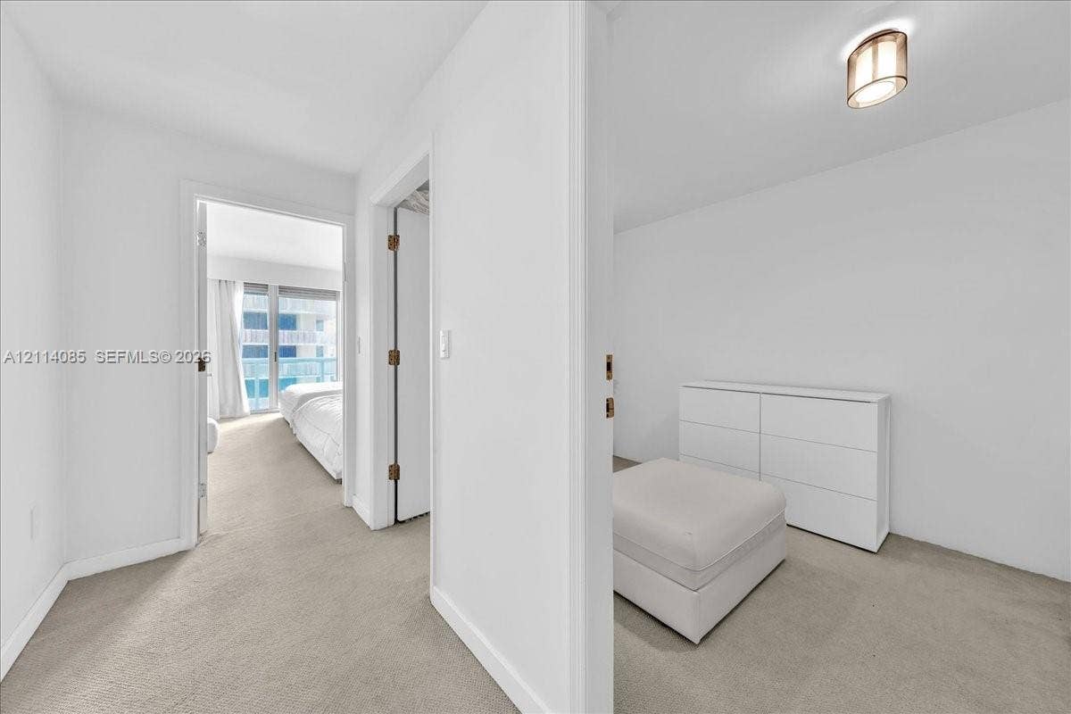 10101 Collins Avenue, #8D, Bal Harbour, FL 33154 Interior space with neutral wall-to-wall carpeting and ceiling-mounted dome light fixture