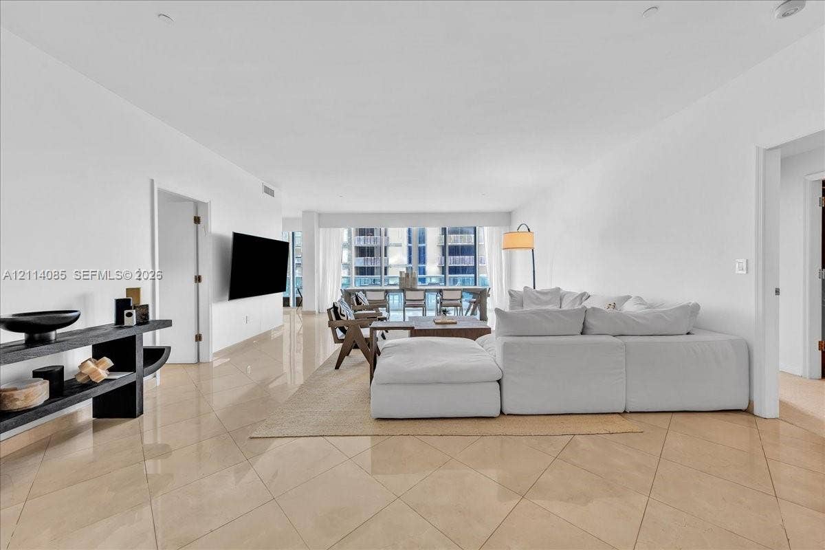 10101 Collins Avenue, #8D, Bal Harbour, FL 33154 Open-concept floor plan with polished tile flooring, recessed lighting, and floor-to-ceiling windows