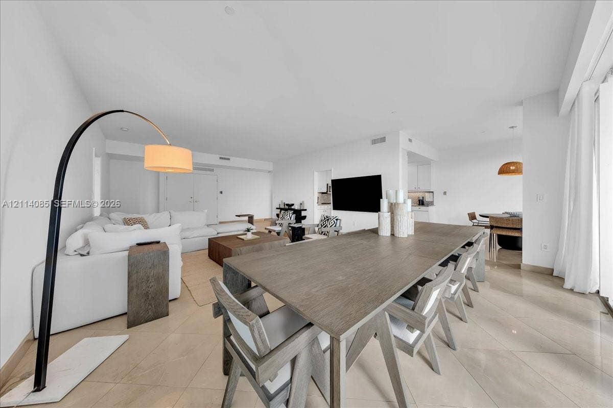 10101 Collins Avenue, #8D, Bal Harbour, FL 33154 Open-concept interior featuring large-format tile flooring, recessed lighting, and crisp white wall finishes