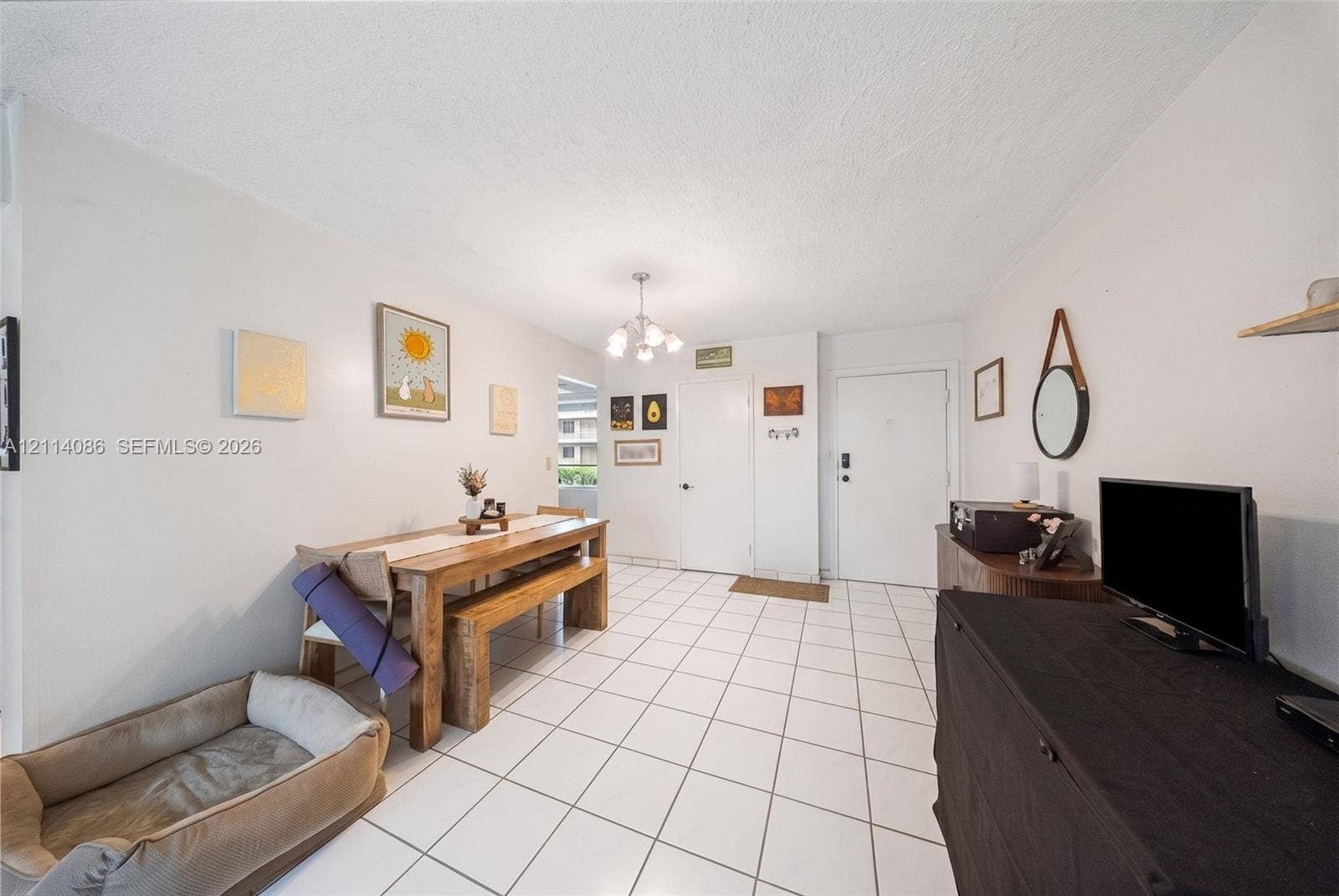 706 NW 87th Avenue, #204, Miami, Miami, FL 33172 Interior space featuring white tile flooring, neutral walls, and a multi-bulb flush-mount ceiling light fixture
