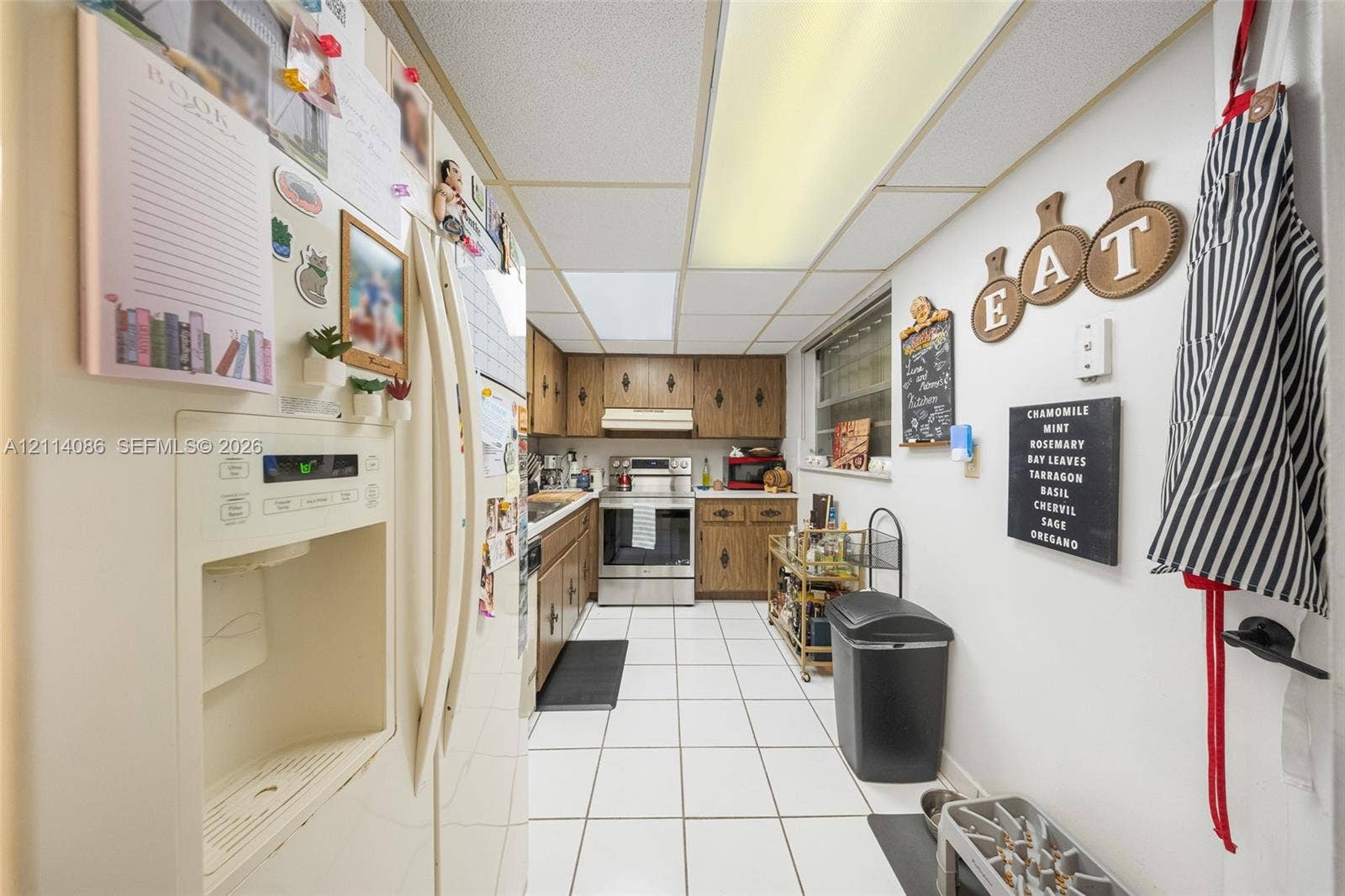 706 NW 87th Avenue, #204, Miami, Miami, FL 33172 Kitchen featuring wood cabinetry, stainless steel appliances, and ceramic tile flooring
