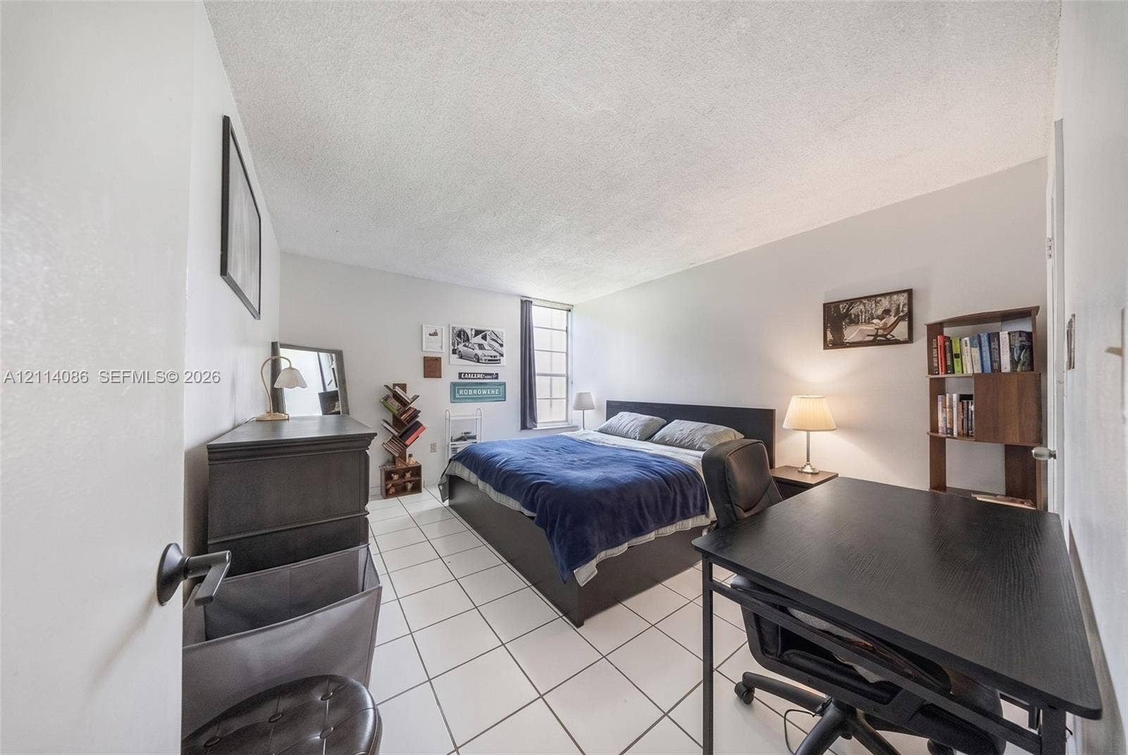 706 NW 87th Avenue, #204, Miami, Miami, FL 33172 Interior room featuring white ceramic tile flooring and a vertical window with multi-pane grid detailing