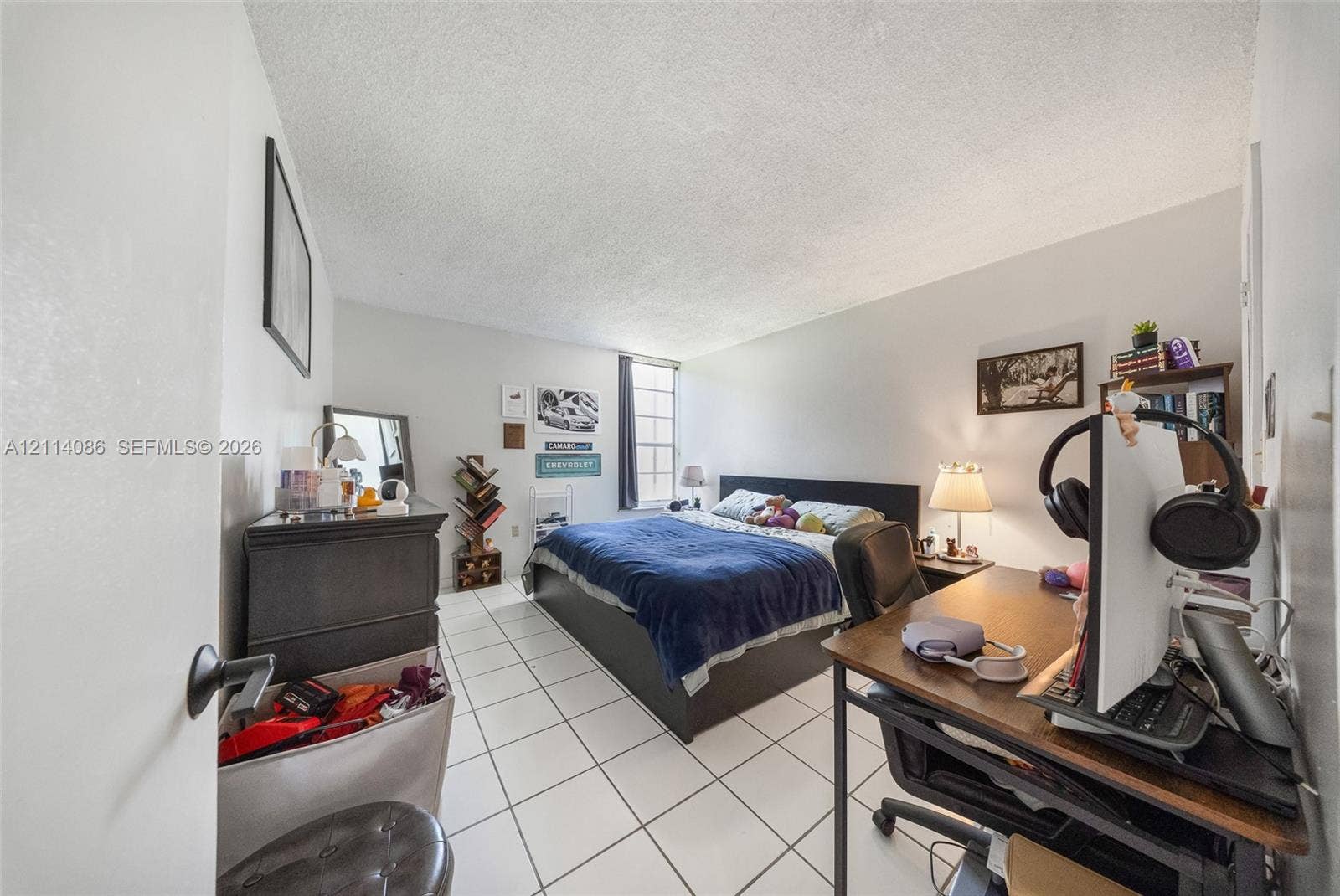 706 NW 87th Avenue, #204, Miami, Miami, FL 33172 Room with white ceramic tile flooring, neutral wall paint, and a single-pane vertical window