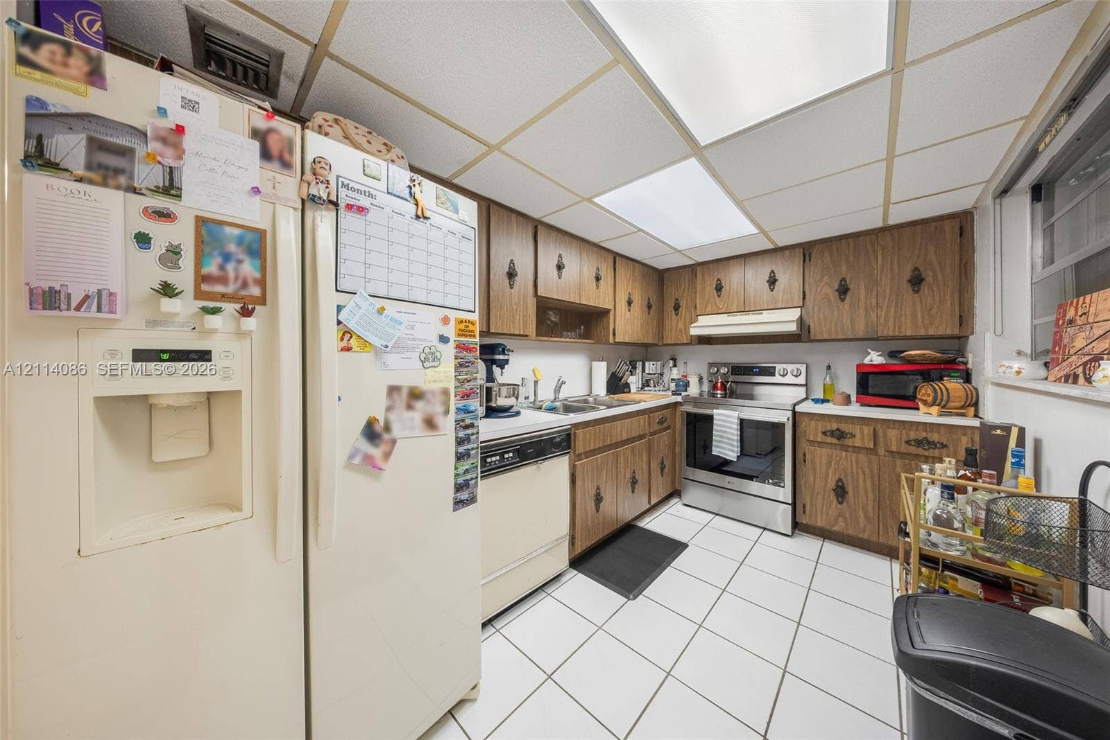 706 NW 87th Avenue, #204, Miami, Miami, FL 33172 Kitchen featuring wood cabinetry, stainless steel range, integrated dishwasher, tiled flooring, and recessed ceiling lighting
