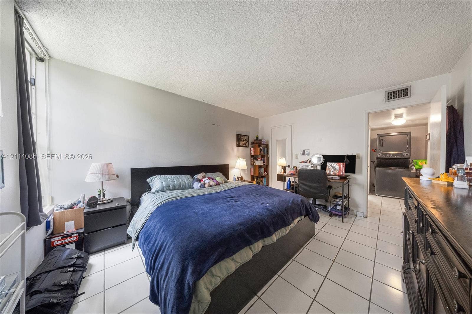 706 NW 87th Avenue, #204, Miami, Miami, FL 33172 Interior space featuring ceramic tile flooring, neutral wall tones, and large vertical window