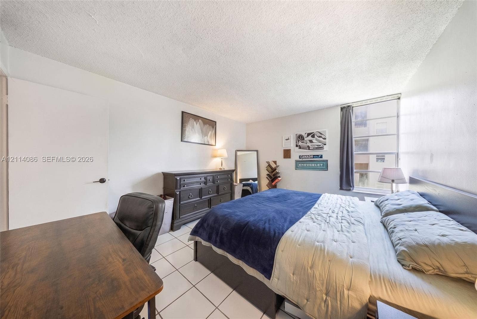 706 NW 87th Avenue, #204, Miami, Miami, FL 33172 Room featuring ceramic tile flooring, neutral wall tones, and a multi-pane window