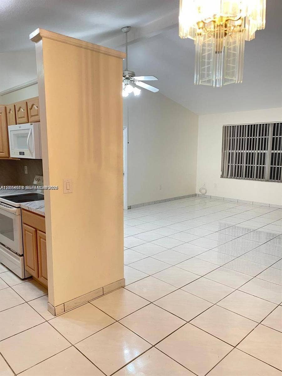 17220 SW 93rd Avenue, #0, Palmetto Bay, Palmetto Bay, FL 33157 Vaulted ceilings, tile flooring, built-in cabinetry, ceiling fan, and multi-tiered glass chandelier
