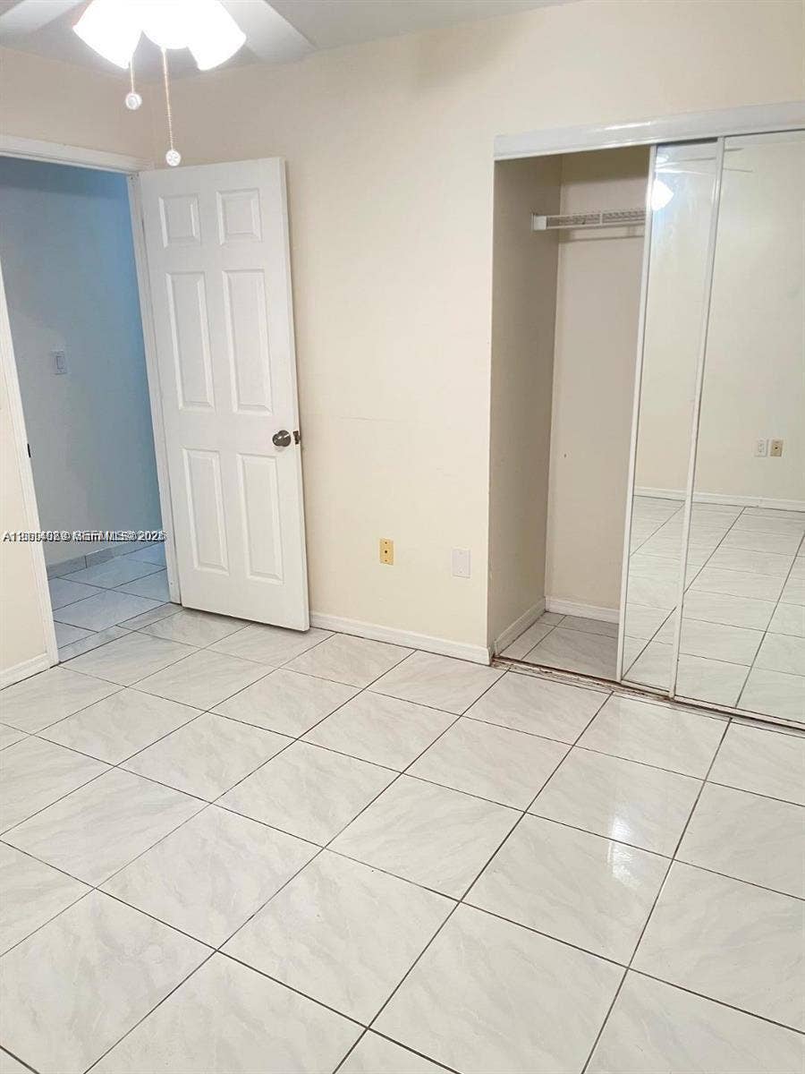17220 SW 93rd Avenue, #0, Palmetto Bay, Palmetto Bay, FL 33157 Ceramic tile flooring throughout, closet with mirrored sliding doors, and ceiling-mounted light fixture