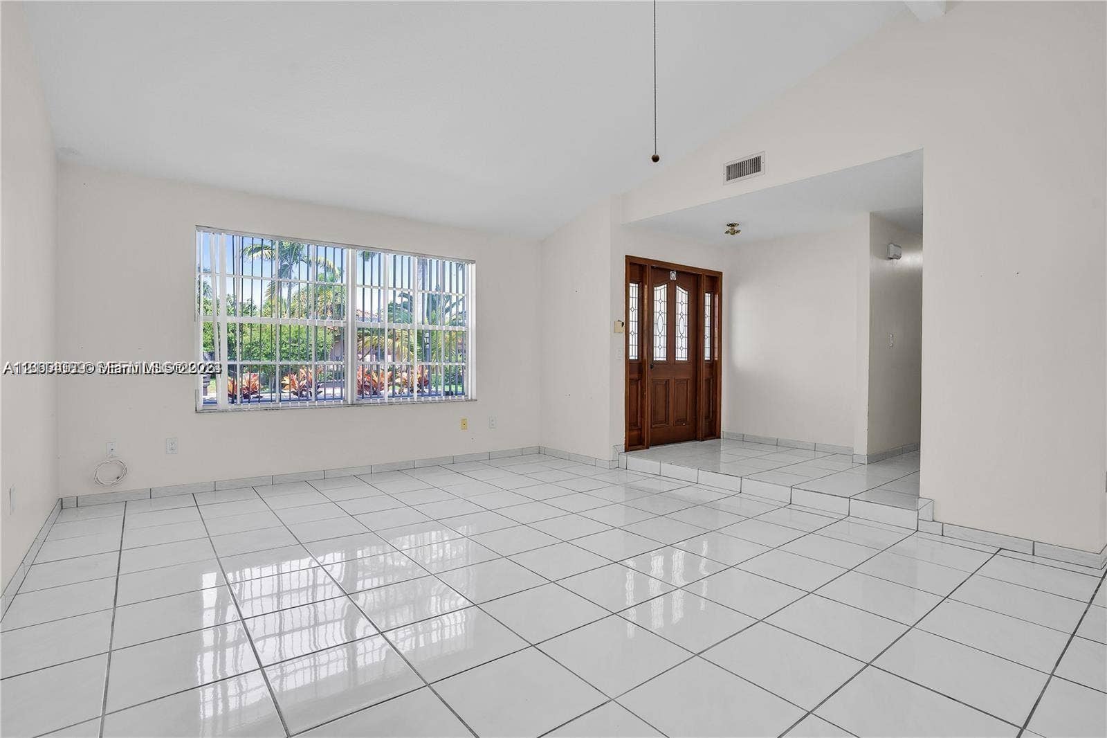 17220 SW 93rd Avenue, #0, Palmetto Bay, Palmetto Bay, FL 33157 Vaulted ceilings, white ceramic tile flooring, large-format window with security bars, and a wooden entry door featuring glass inserts