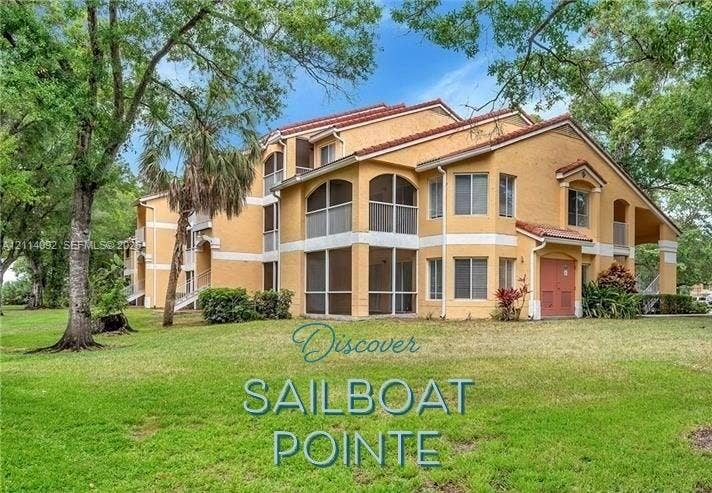 2667 NW 33rd Street, #2413, Oakland Park, Oakland Park, FL 33309 Multi-story exterior featuring a stucco facade, red tile roof, and multiple screened-in balconies
