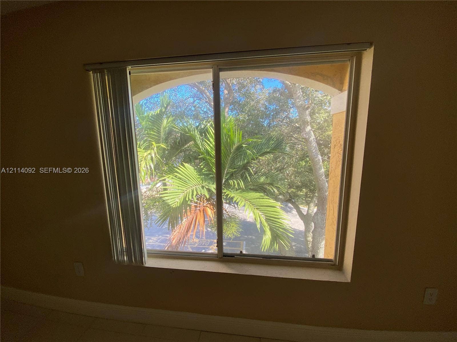 2667 NW 33rd Street, #2413, Oakland Park, Oakland Park, FL 33309 Single-hung window featuring an arched architectural frame and exterior greenery