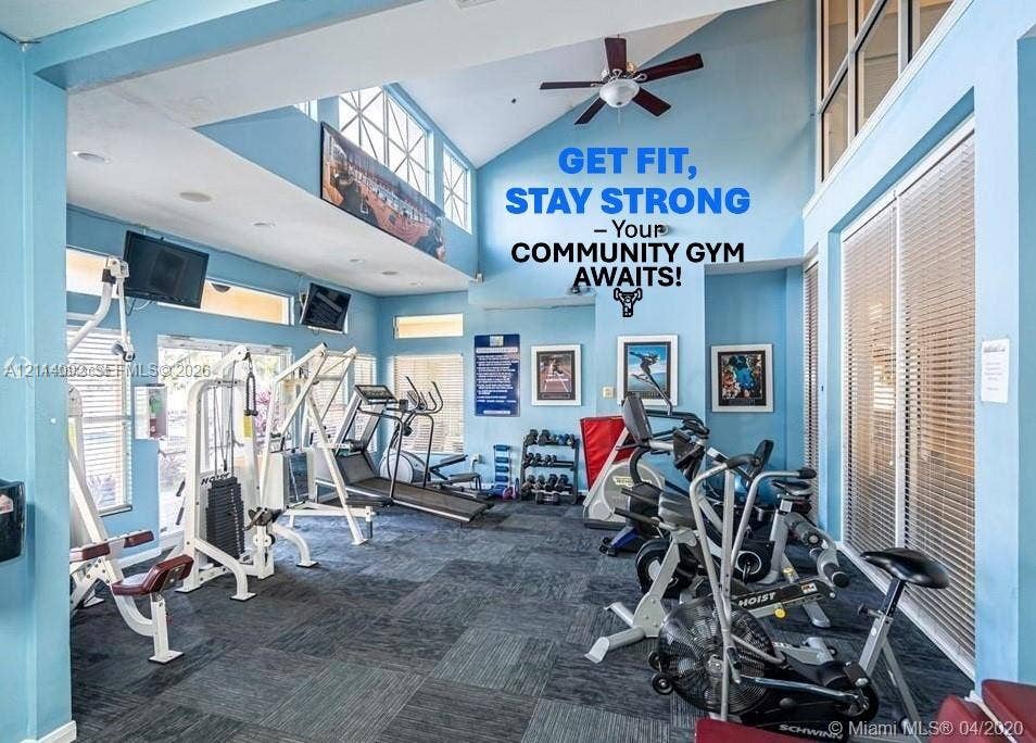 2667 NW 33rd Street, #2413, Oakland Park, Oakland Park, FL 33309 Fitness center featuring vaulted ceilings, oversized windows, and neutral carpeting