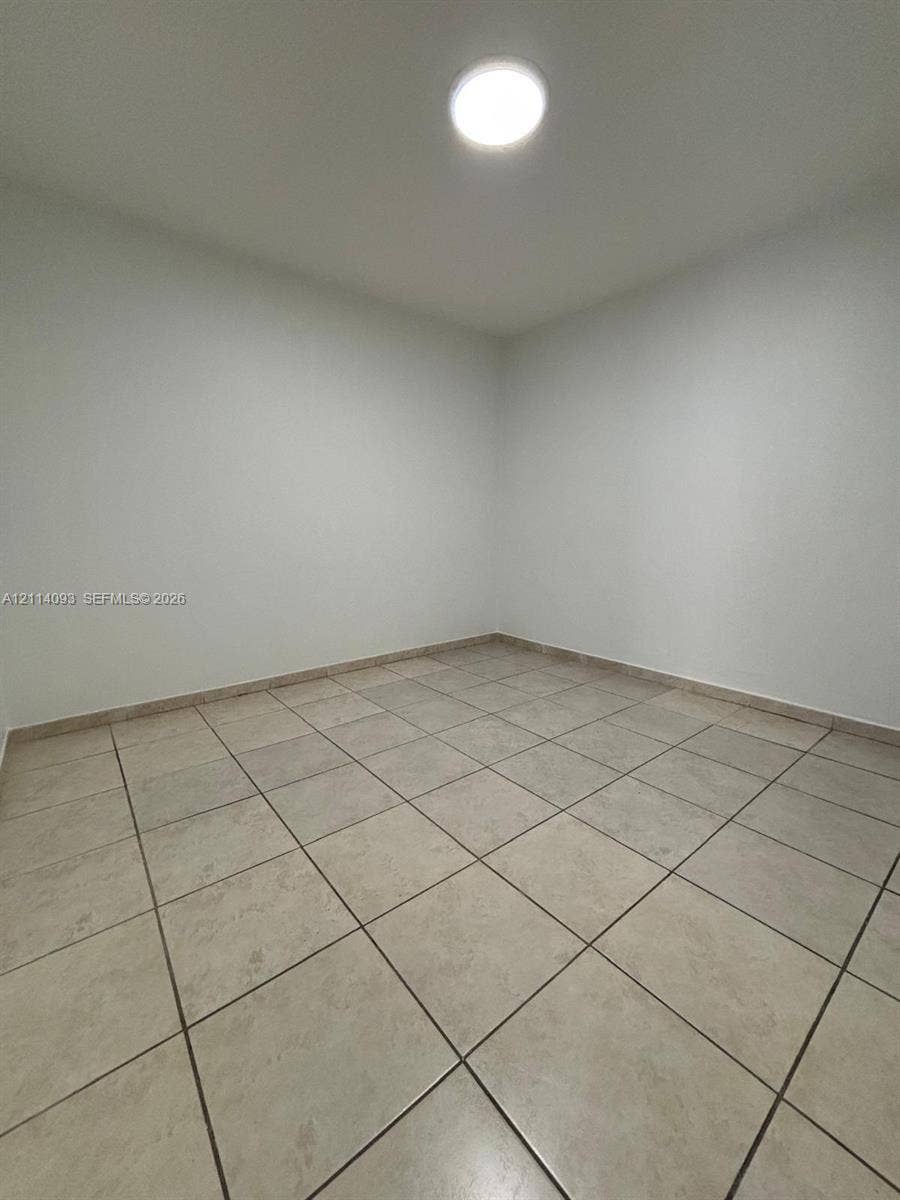 4916 SW 142nd Place, #4916, Miami, Miami, FL 33175 Interior space featuring neutral wall paint, ceramic floor tiling, and a flush-mount ceiling light fixture