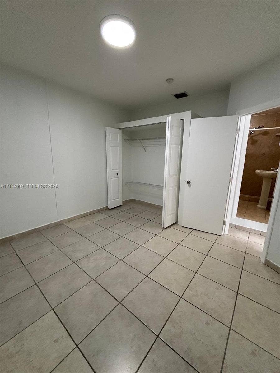 4916 SW 142nd Place, #4916, Miami, Miami, FL 33175 Neutral-toned ceramic tile flooring, built-in closet with shelving, and flush-mount ceiling lighting