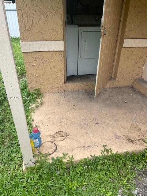 14180 NW 22nd Court, #0, Opa Locka, Opa Locka, FL 33054 Exterior utility closet featuring a concrete landing, stucco siding, and dedicated appliance storage