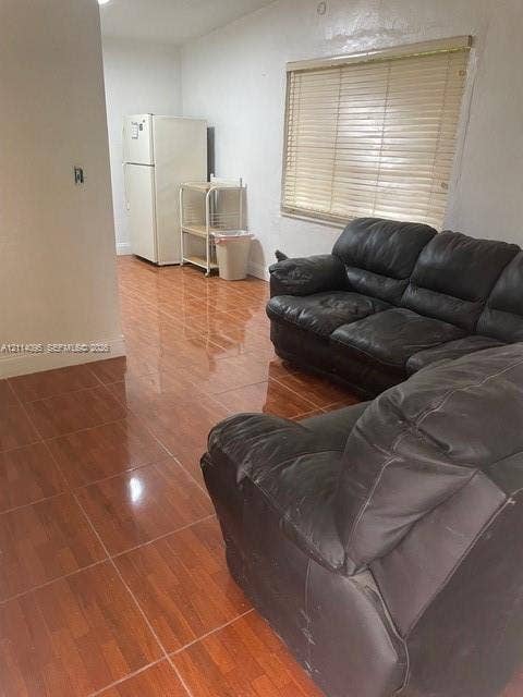 14180 NW 22nd Court, #0, Opa Locka, Opa Locka, FL 33054 Glossy ceramic tile flooring featuring a wood-tone finish and horizontal window blinds