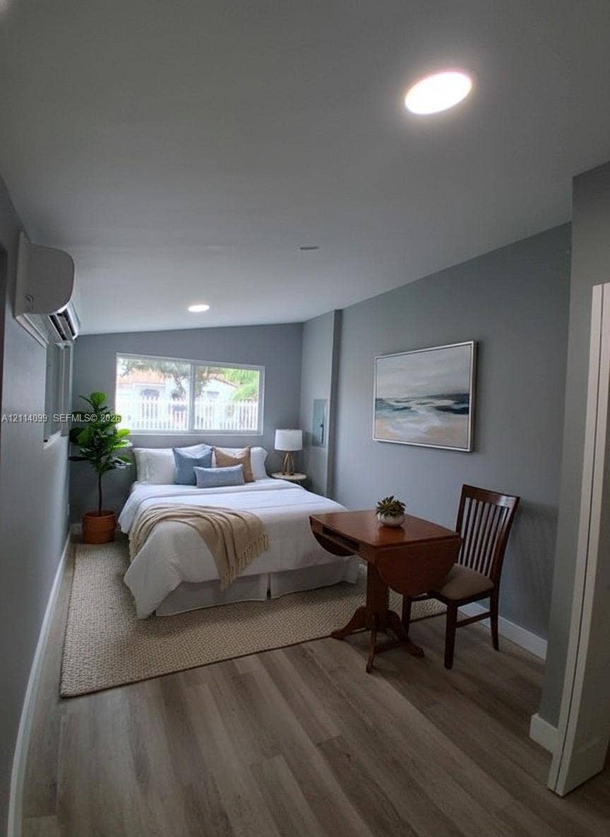 3052 SW 6th Street, Miami, FL 33135 Wood-finish flooring, recessed lighting, wall-mounted climate control unit, and a horizontal sliding window