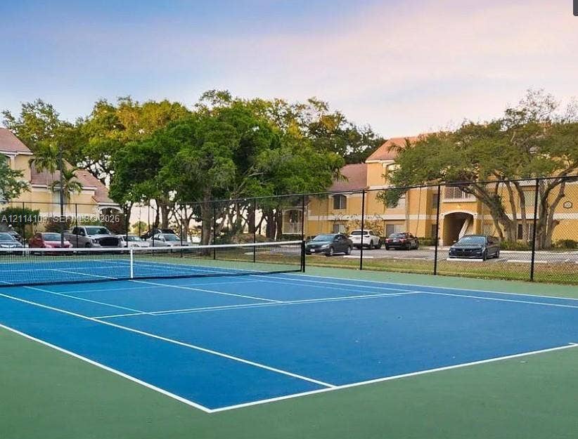 2485 NW 33rd Street, #1602, Oakland Park, Oakland Park, FL 33309 Tennis court with blue and green court surfacing, perimeter chain-link fencing, and white court markings