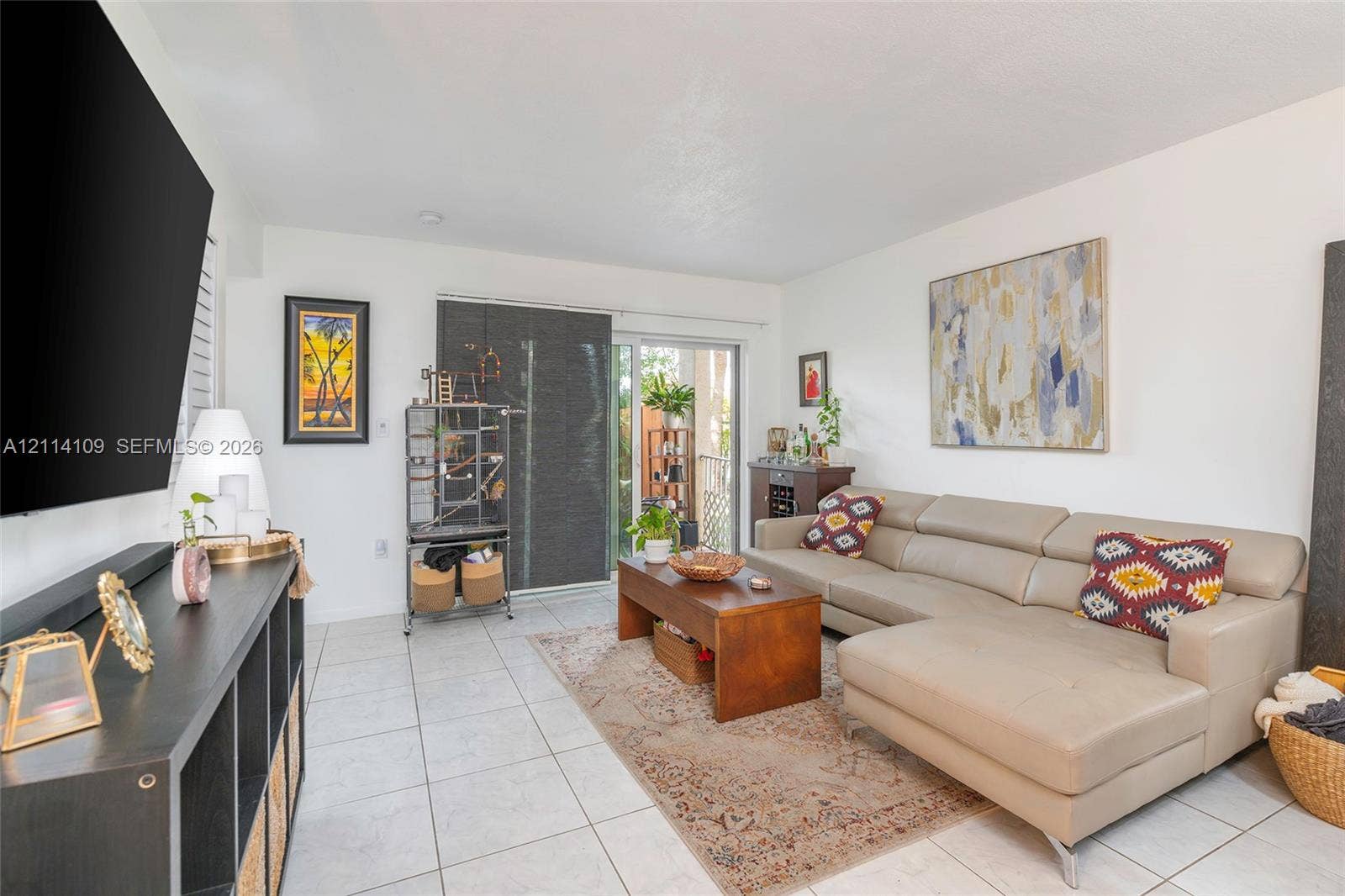15761 SW 137th Avenue, #104, Miami, Miami, FL 33177 Living space featuring neutral ceramic tile flooring and a sliding glass door providing external access