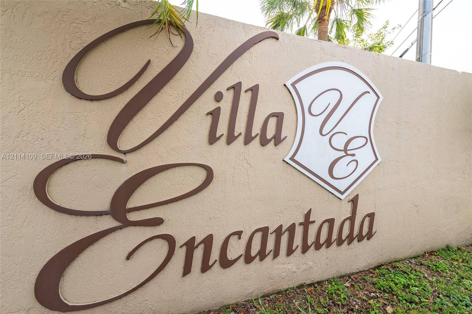 15761 SW 137th Avenue, #104, Miami, Miami, FL 33177 Stucco monument sign featuring raised, metallic-finish lettering and a decorative shield emblem