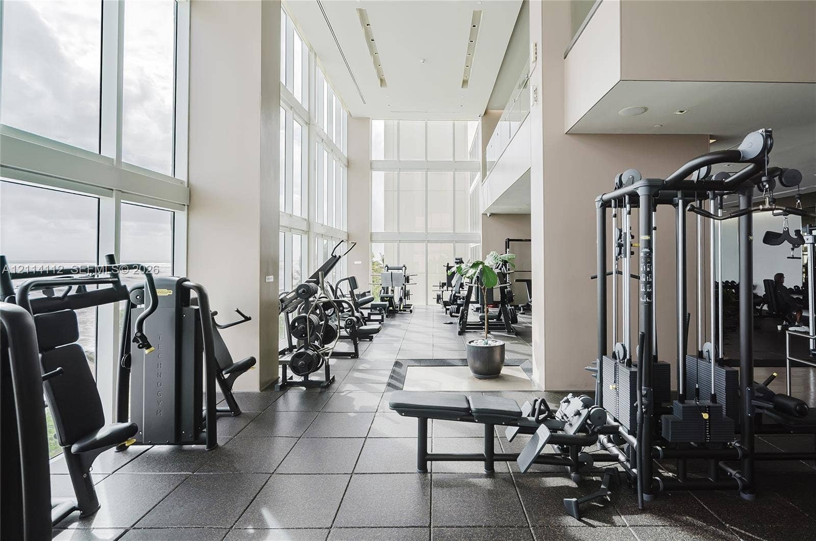 1850 S Ocean Drive, #4008, Hallandale Beach, FL 33009 Fitness center featuring floor-to-ceiling windows, high ceilings, recessed lighting, and large-format tile flooring