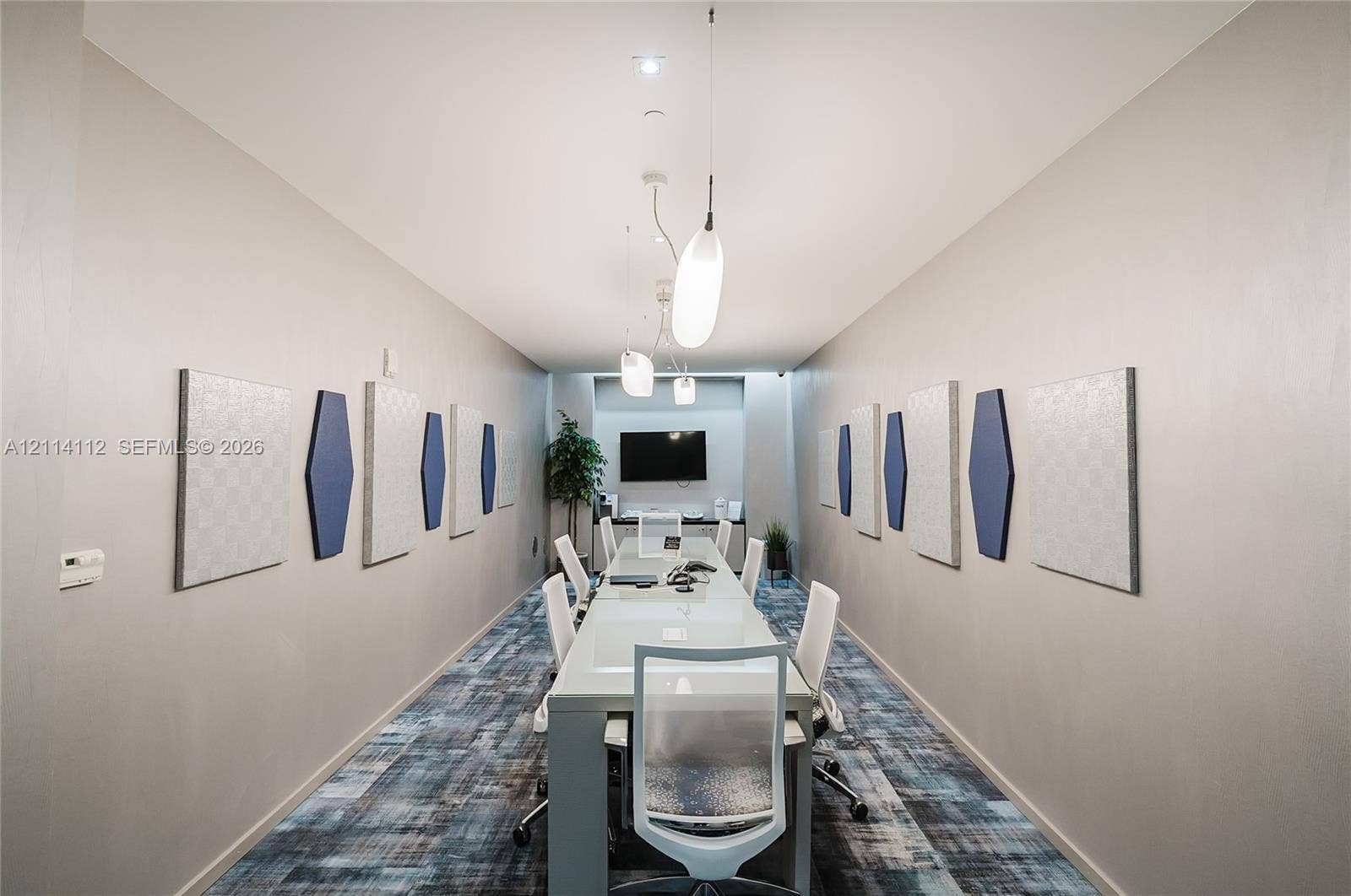 1850 S Ocean Drive, #4008, Hallandale Beach, FL 33009 Conference room featuring patterned wall-to-wall carpeting, recessed ceiling lighting, elongated pendant fixtures, and decorative wall-mounted acoustic panels
