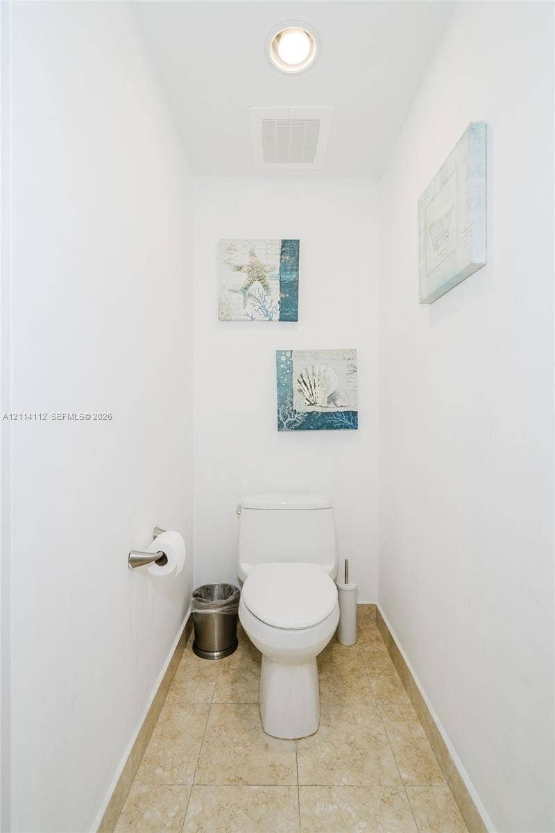 1850 S Ocean Drive, #4008, Hallandale Beach, FL 33009 White dual-flush toilet, recessed ceiling lighting, and neutral-toned floor tiling