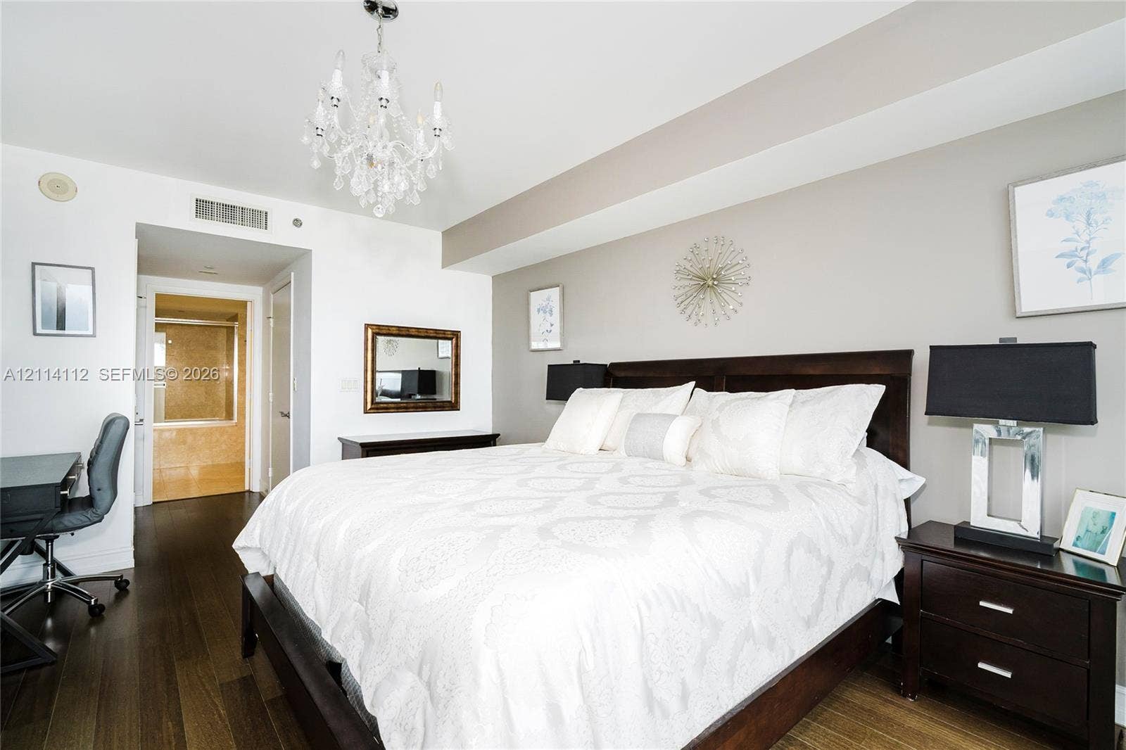 1850 S Ocean Drive, #4008, Hallandale Beach, FL 33009 Room featuring dark wood-finish flooring, a tiered crystal chandelier, and a recessed ceiling architectural detail