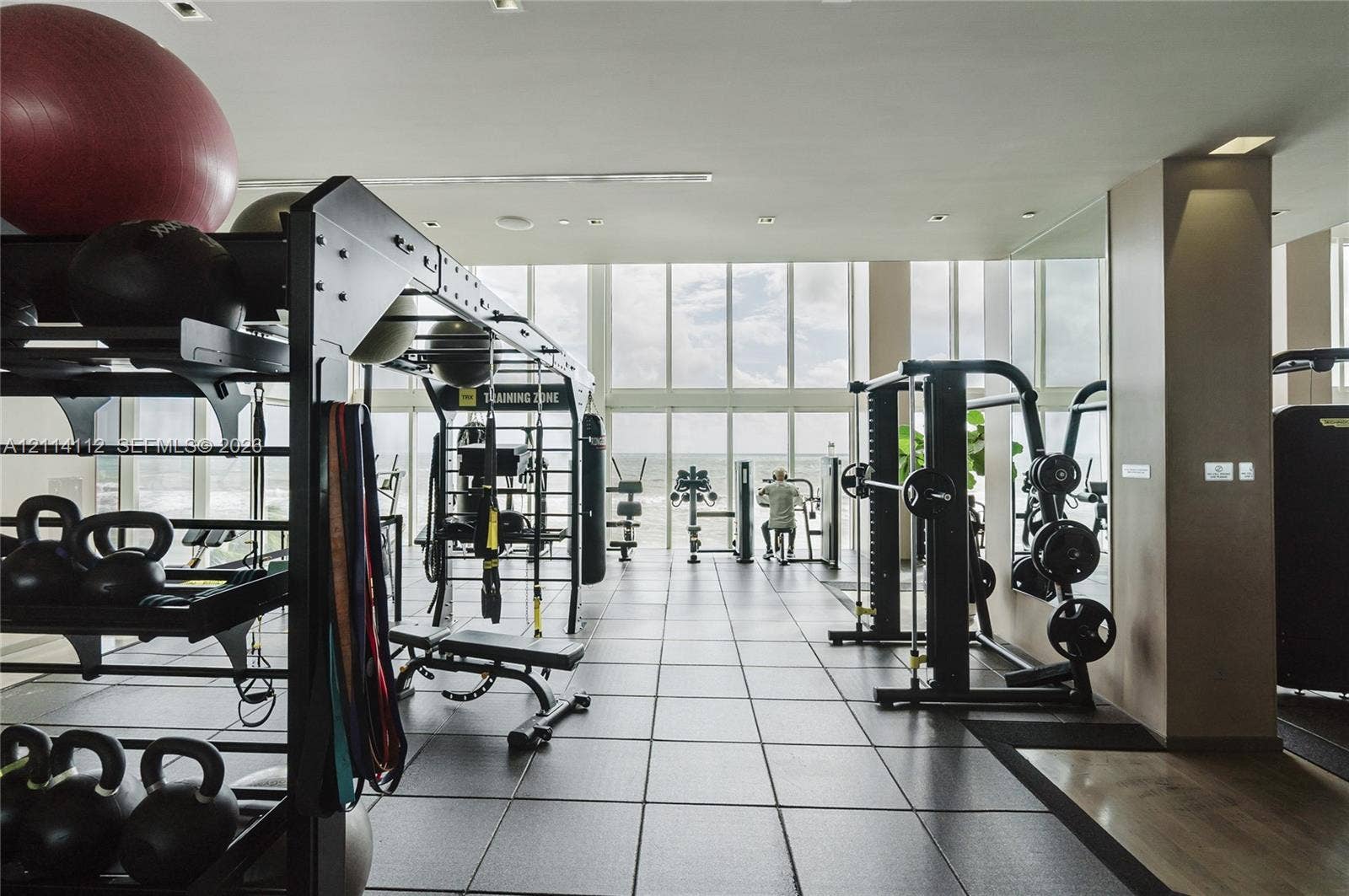 1850 S Ocean Drive, #4008, Hallandale Beach, FL 33009 Fitness facility featuring floor-to-ceiling windows, high ceilings with recessed lighting, and large-format tile flooring