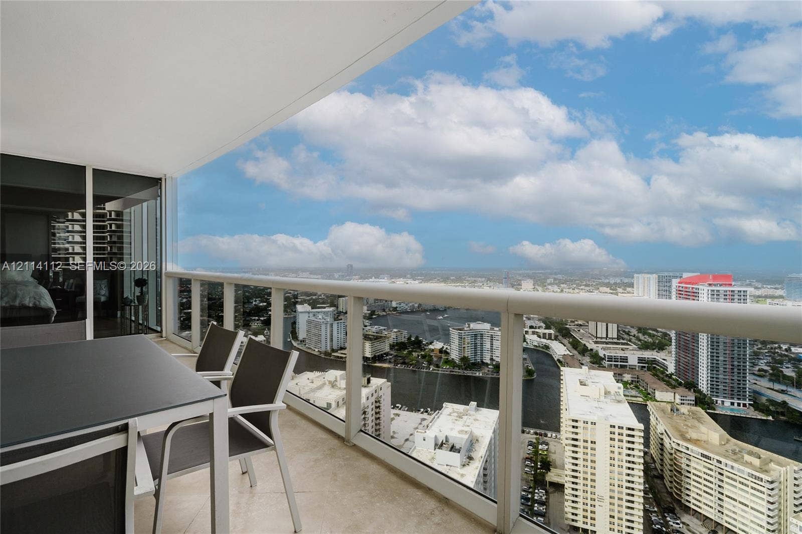 1850 S Ocean Drive, #4008, Hallandale Beach, FL 33009 Private balcony featuring tile flooring and a structural glass-panel railing