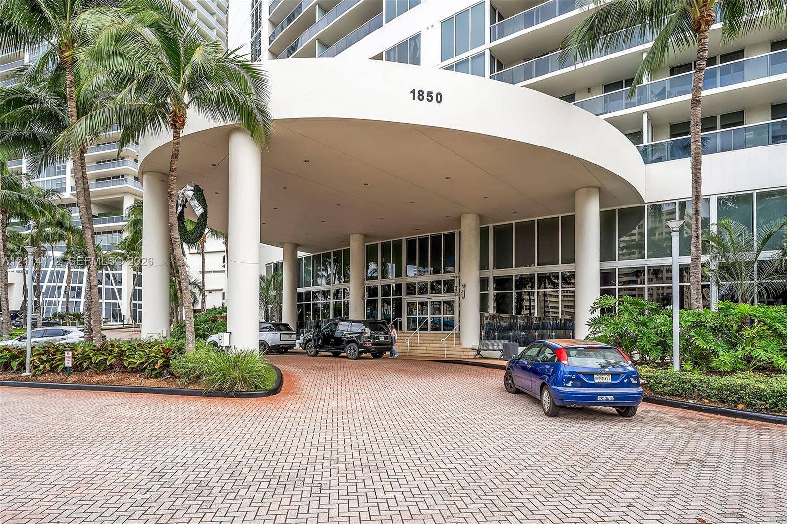 1850 S Ocean Drive, #4008, Hallandale Beach, FL 33009 Covered motor court entrance featuring structural columns and a paver stone driveway