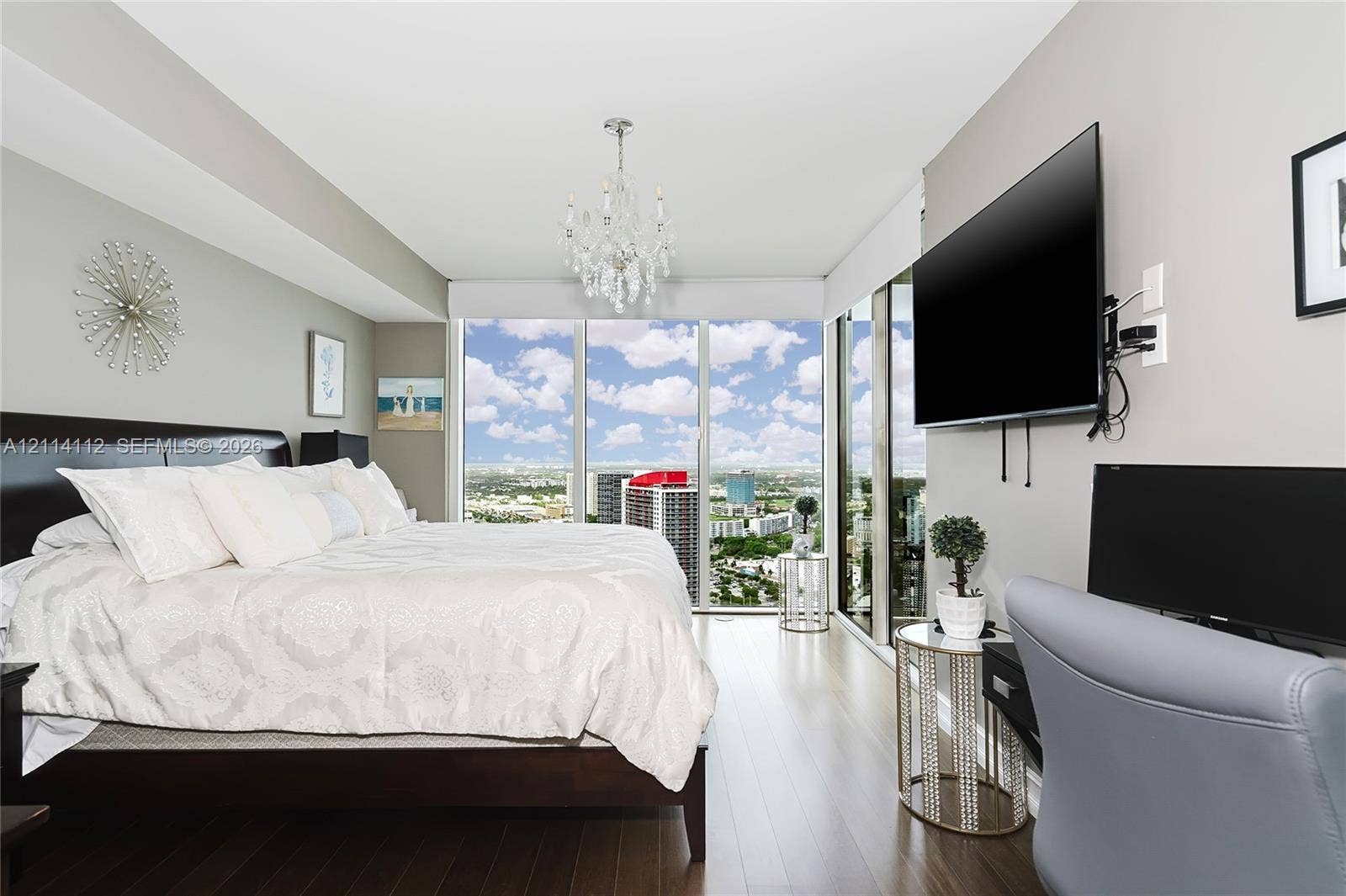 1850 S Ocean Drive, #4008, Hallandale Beach, FL 33009 Floor-to-ceiling windows, wood-finish flooring, and a crystal chandelier