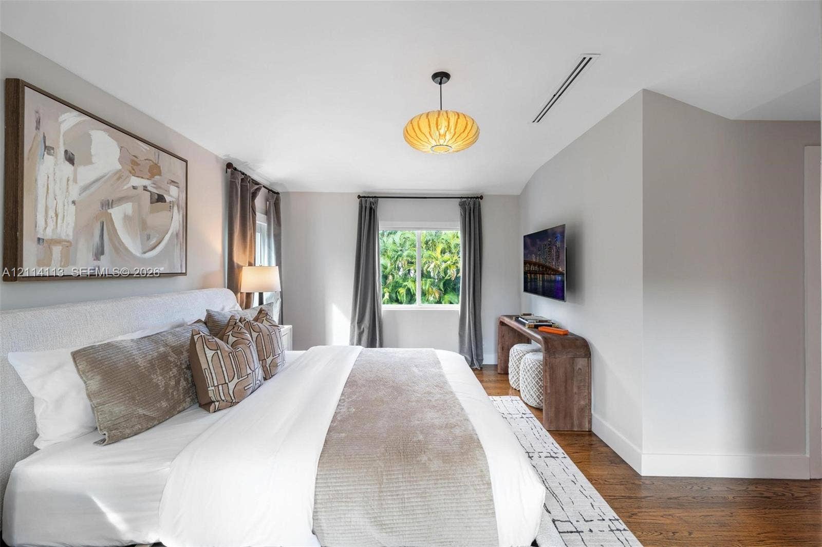 5386 Alton Road, Miami Beach, FL 33140 Bedroom featuring dark wood-finish flooring, a contemporary pendant light fixture, and recessed ceiling lighting