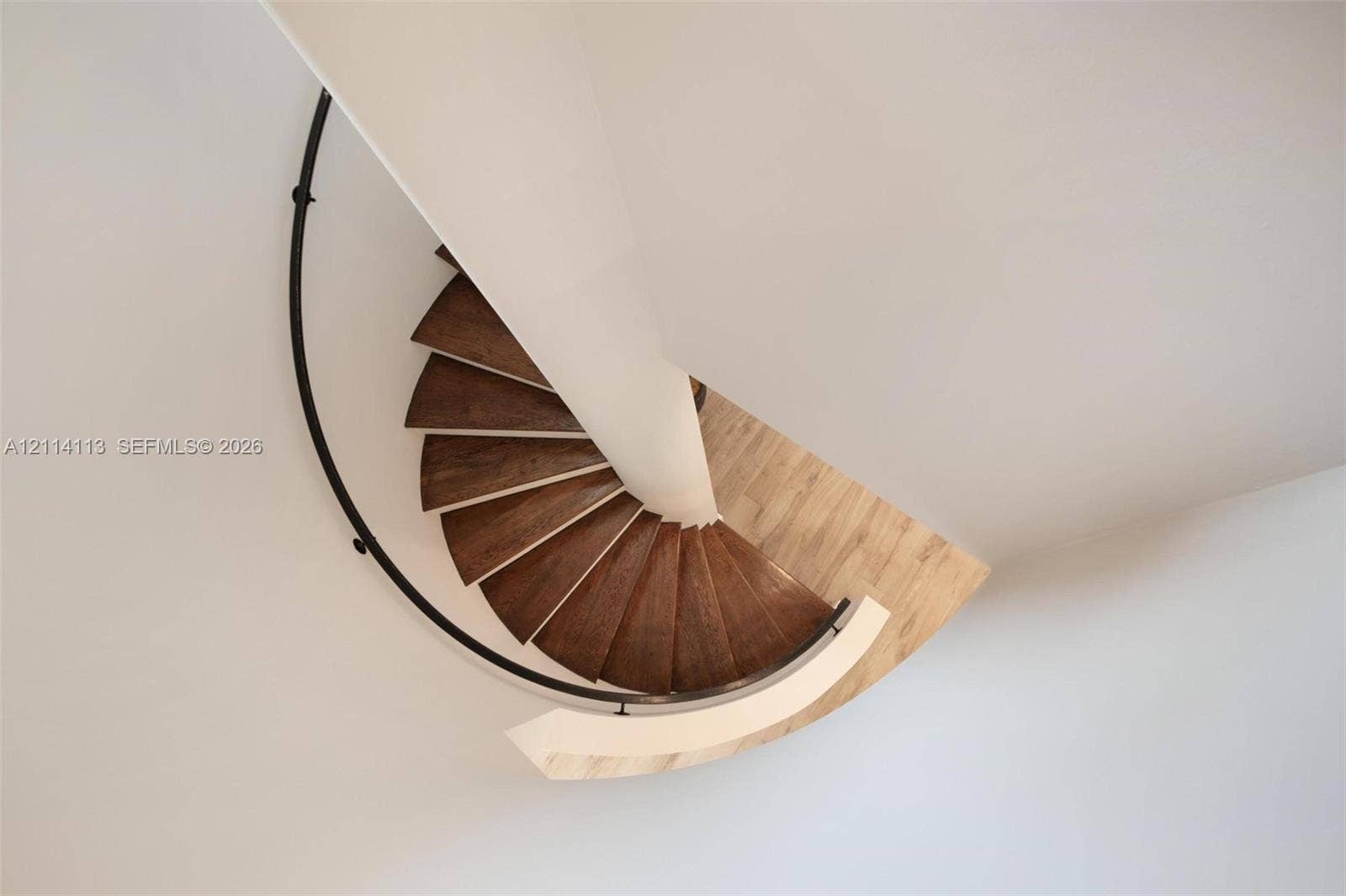 5386 Alton Road, Miami Beach, FL 33140 Spiral staircase featuring wood-finish treads, a central support column