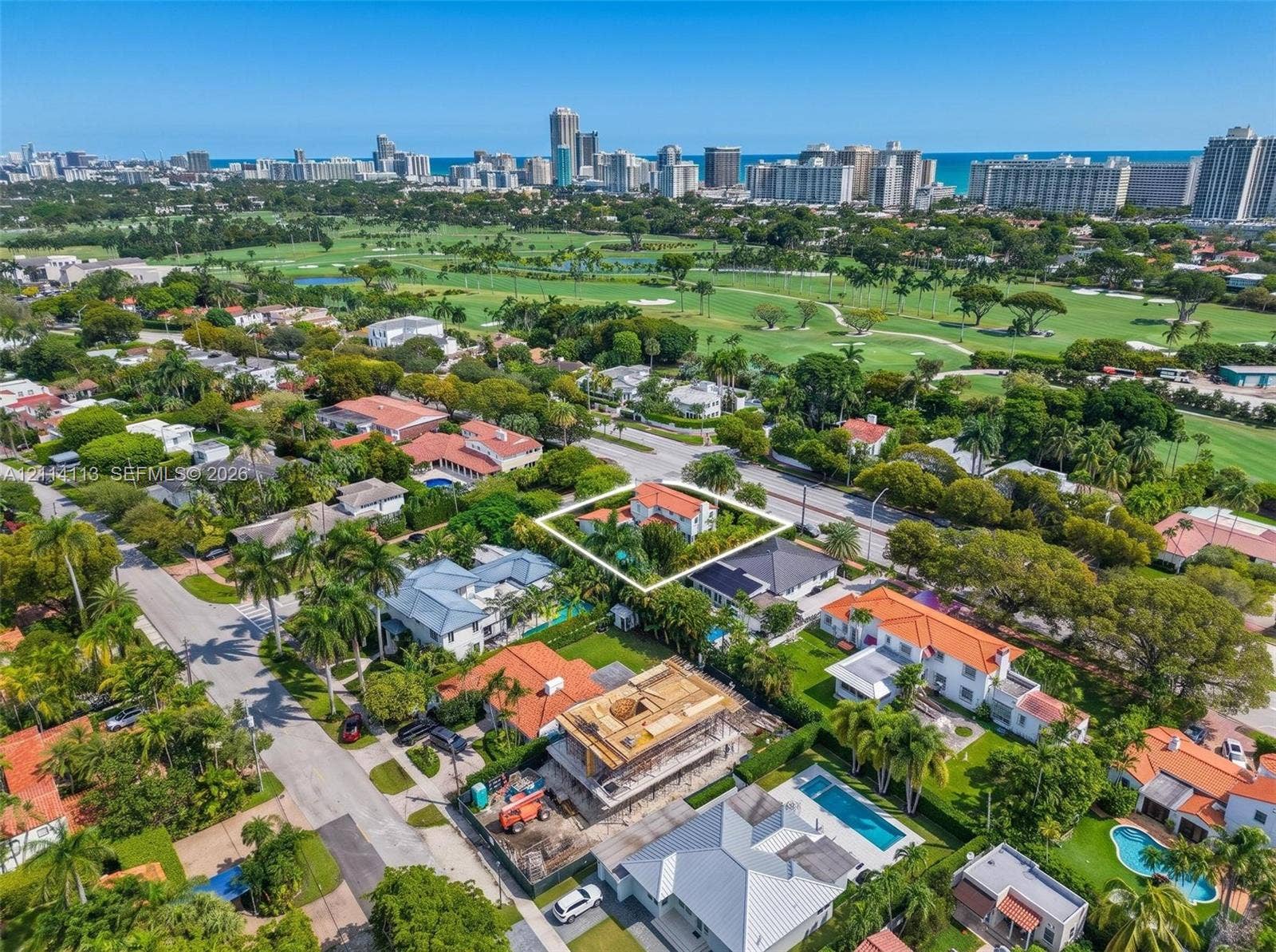 5386 Alton Road, Miami Beach, FL 33140 Aerial perspective of the residence next to prestigious La Gorce golf club, mature landscaping situated within a coastal urban environment