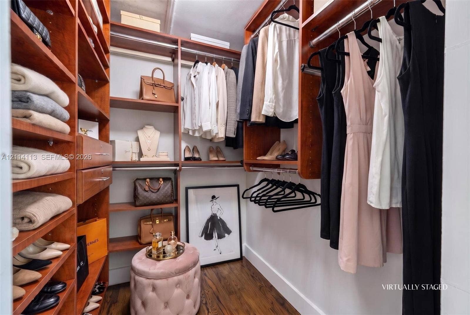 5386 Alton Road, Miami Beach, FL 33140 Custom walk-in closet featuring floor-to-ceiling wooden cabinetry, built-in shelving