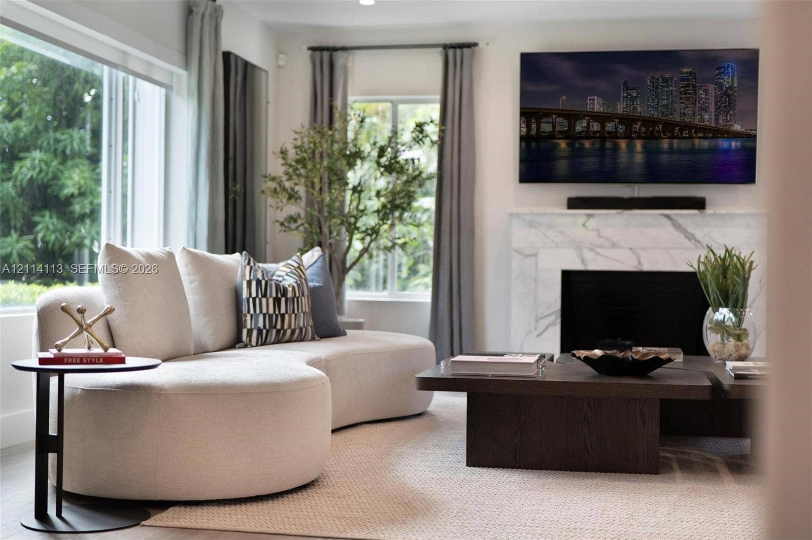 5386 Alton Road, Miami Beach, FL 33140 Living area featuring a floor-to-ceiling window, large-format stone fireplace surround, and recessed ceiling lighting