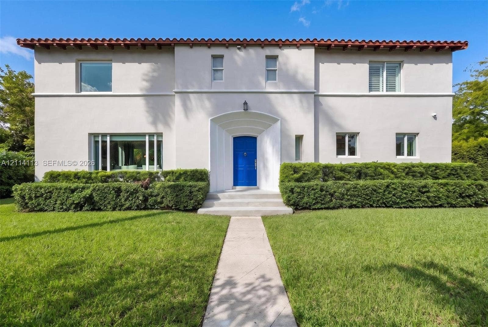 5386 Alton Road, Miami Beach, FL 33140 Art Deco facade, red tile roof, recessed arched entryway, and multi-paned windows