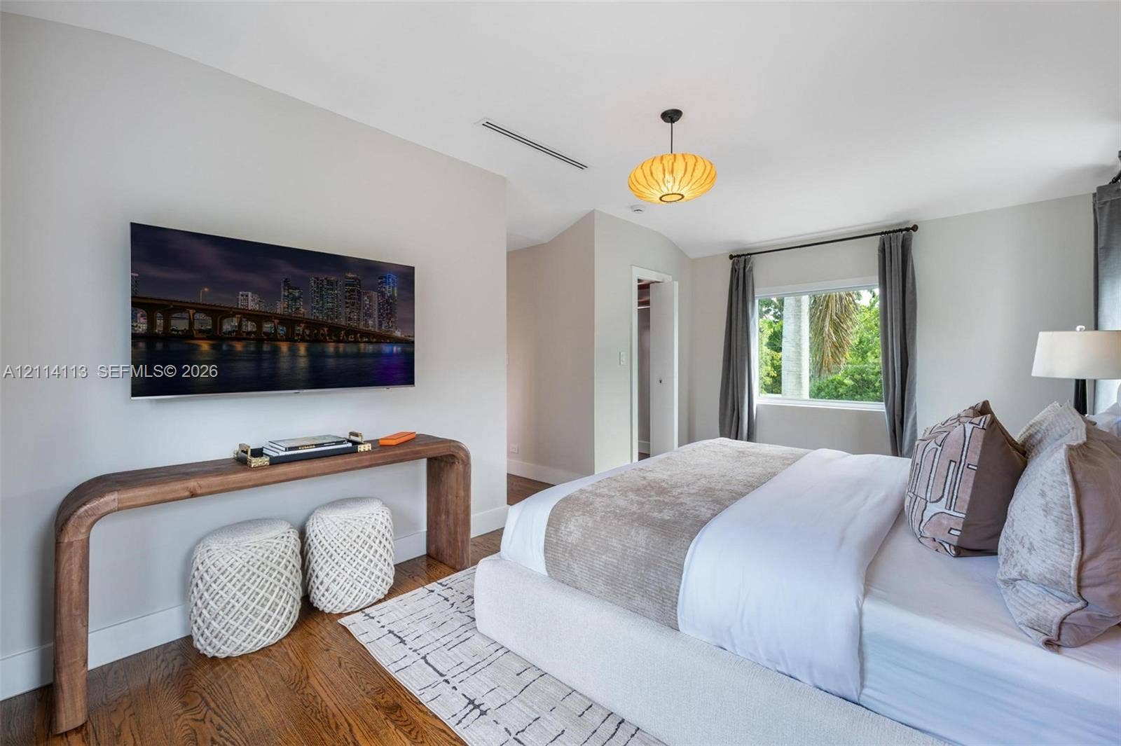 5386 Alton Road, Miami Beach, FL 33140 Wood-finish flooring, neutral wall tones, recessed ceiling lighting, and a drum-style pendant light fixture