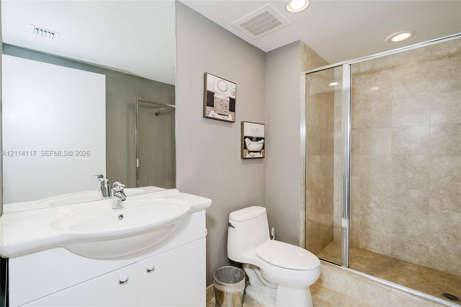 1850 S Ocean Drive, #4008, Hallandale Beach, Hallandale Beach, FL 33009 Bathroom featuring a white vanity with an integrated sink, a large wall-mounted mirror, a walk-in shower with stone-finish tile surround, and recessed lighting
