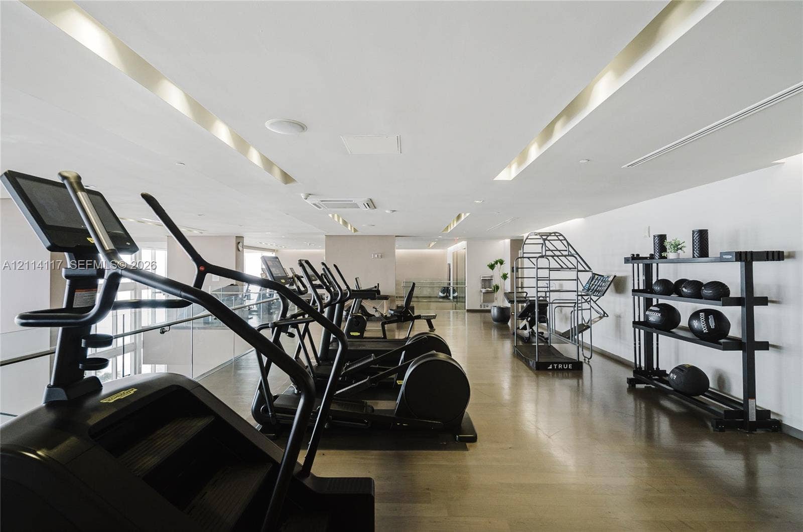 1850 S Ocean Drive, #4008, Hallandale Beach, Hallandale Beach, FL 33009 Fitness center featuring wood-finish flooring, recessed linear ceiling lighting, and a glass partition wall