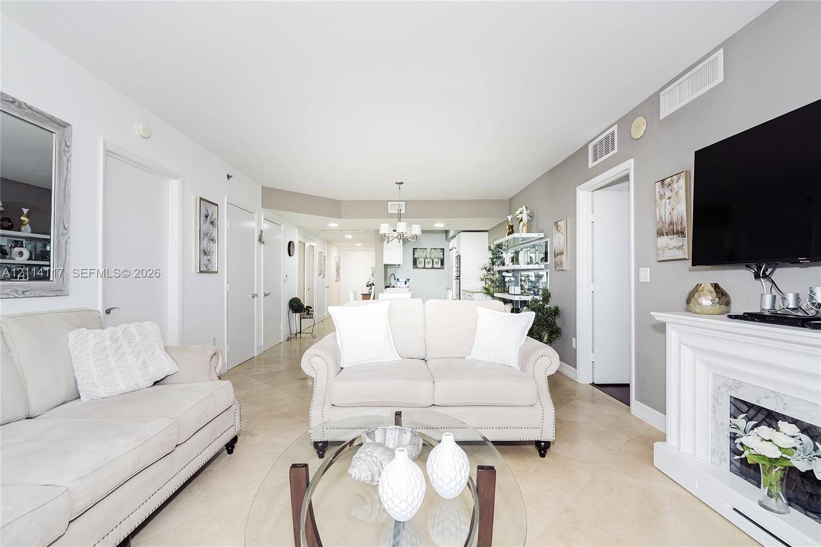 1850 S Ocean Drive, #4008, Hallandale Beach, Hallandale Beach, FL 33009 Open-concept interior featuring large-format neutral tile flooring, a built-in fireplace with detailed surround, and recessed ceiling lighting